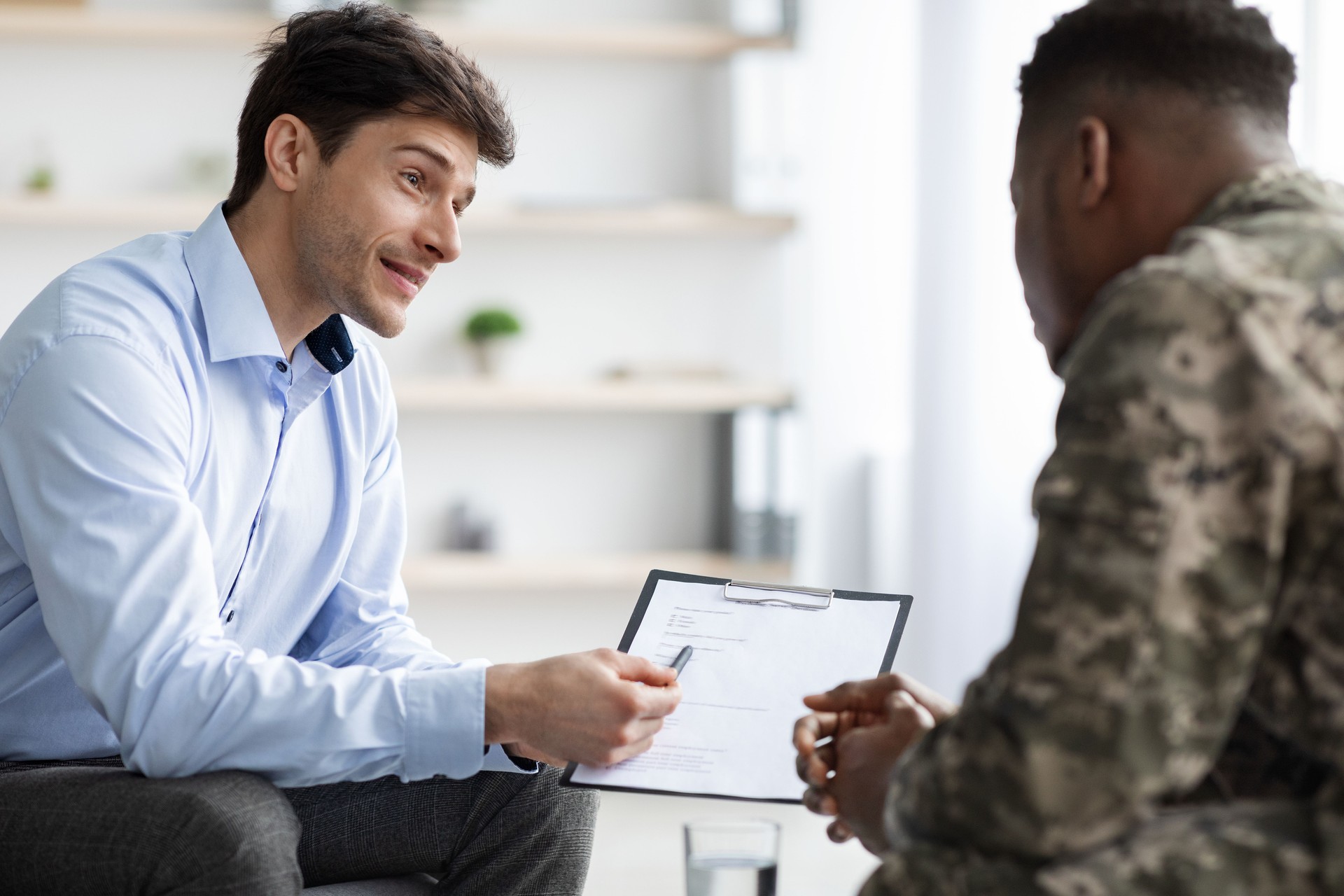 Psychologist giving african american military man recommendations