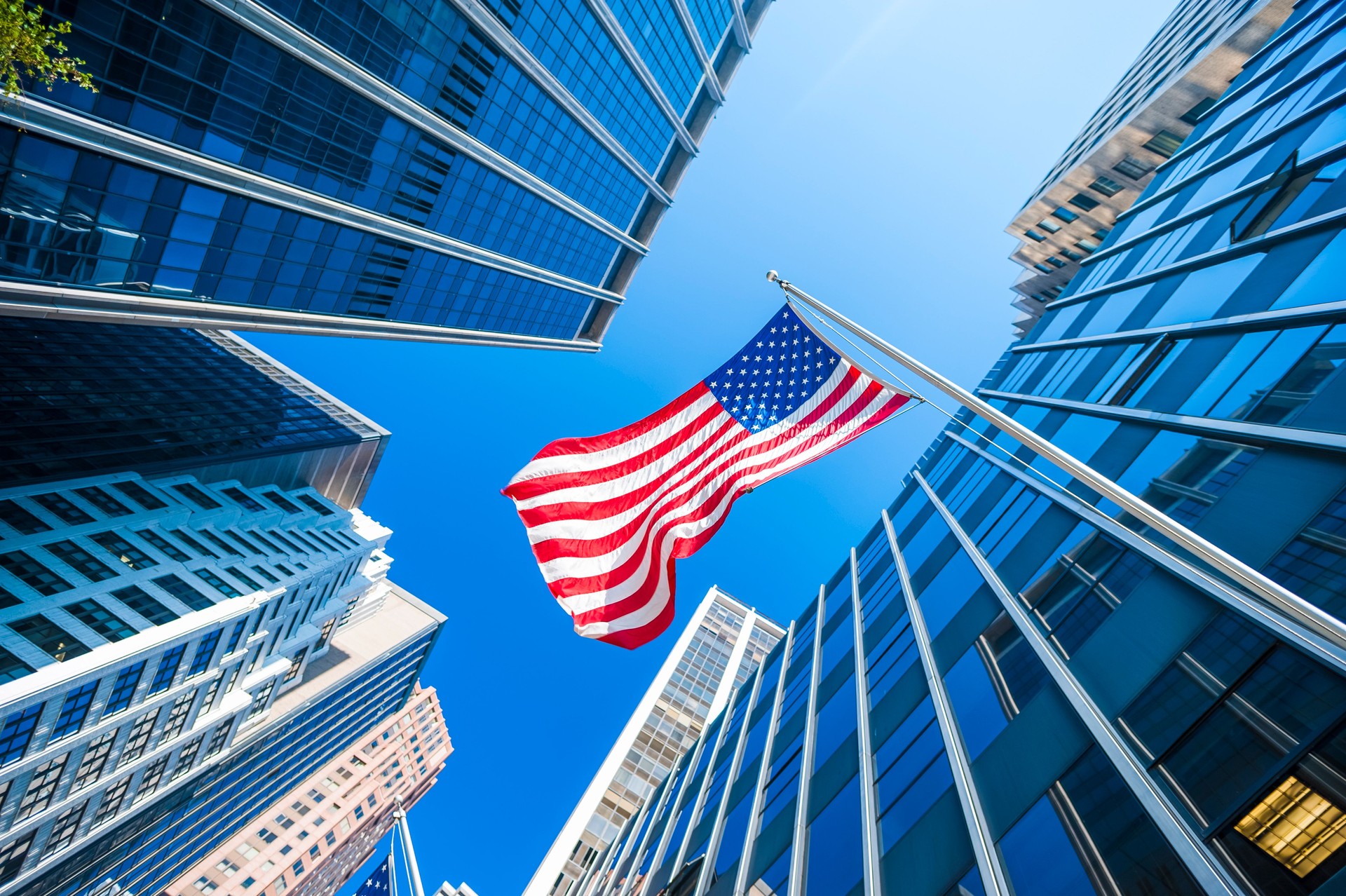 USA flag and contemporary glass skyscrapers in New York